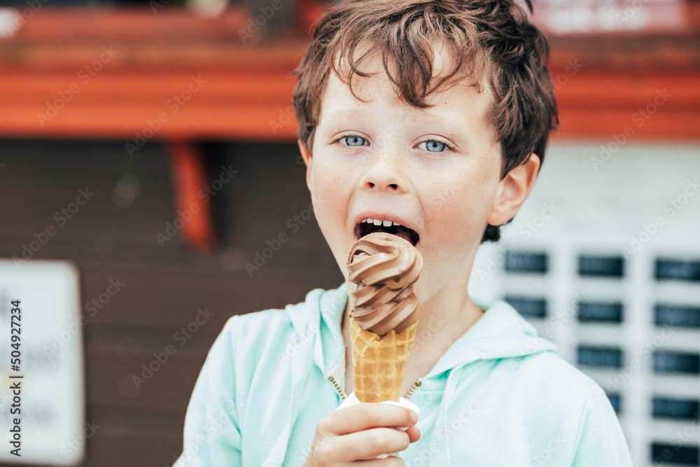 Boy eating chocolate ice cream Stock Photo | Adobe Stock