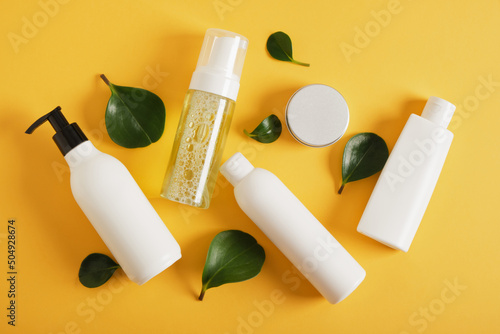 Blank mockup cosmetic packages on yellow background