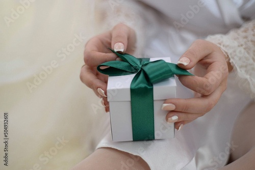 The bride opens her gift on the wedding day