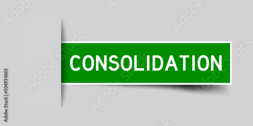 Inserted green color label sticker with word consolidation on gray background