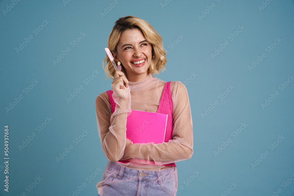 Young blonde woman smiling while posing exercise book Young blonde woman smiling while posing exercise book