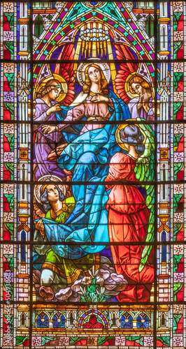 VALENCIA, SPAIN - FEBRUAR 17, 2022: The Assumption in neo-gothic stained glass of  church Basilica de San Vicente Ferrer by Talleres Maumejean Hermanos from 20. cent. photo