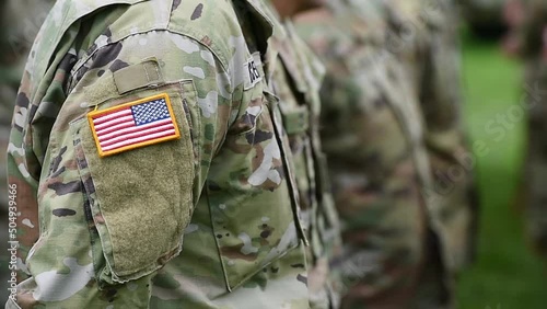 Detail clip with american flag on soldier uniform standing in military position during ceremony