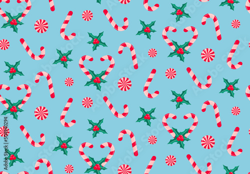 Romantic Christmas pattern with candy canes, holly leaves and berries, peppermint swirl candies.