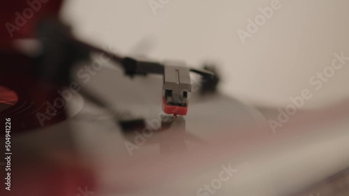 Old phonograph  being played in a cozy room. a vinyl needle turntable retro cd. macro shot MXF photo