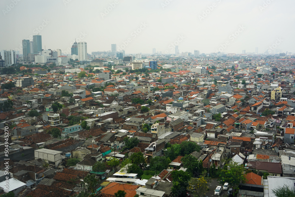 Surabaya, Indonesia - May, 2022 : 
View of Surabaya city from the top floor of a very high building so that settlements and tall buildings can be seen. Port, center of business, trade and government.
