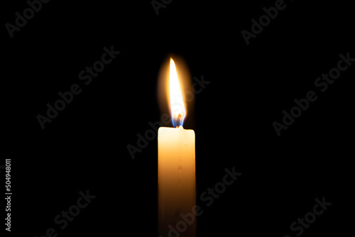 Schilderij op canvas Yellow candle is burning on isolated black background