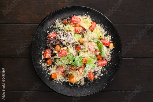 Caesar salad with fresh vegetables and croutons