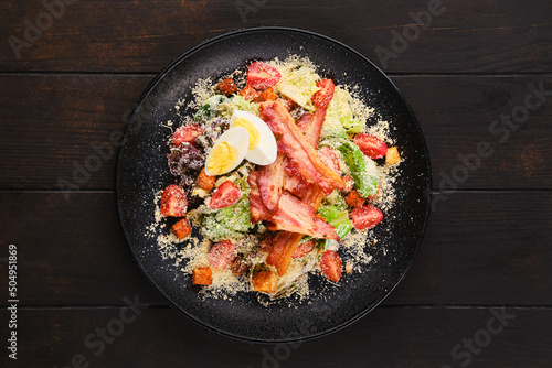 Salad with bacon, egg, fresh vegetables and croutons