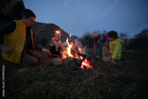 Children after hiking have a picnic - group of happy friends