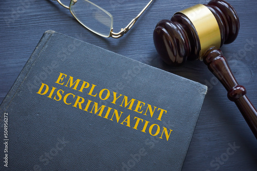 Law about employment discrimination and gavel on the table.