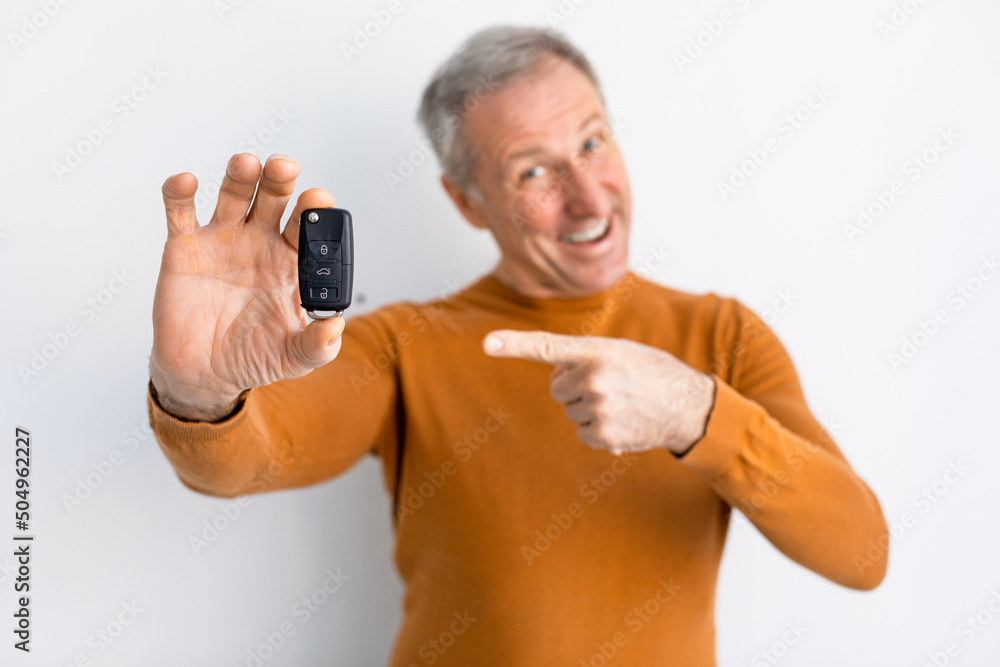 Excited Man Holding Car Key And Pointing, White Background
