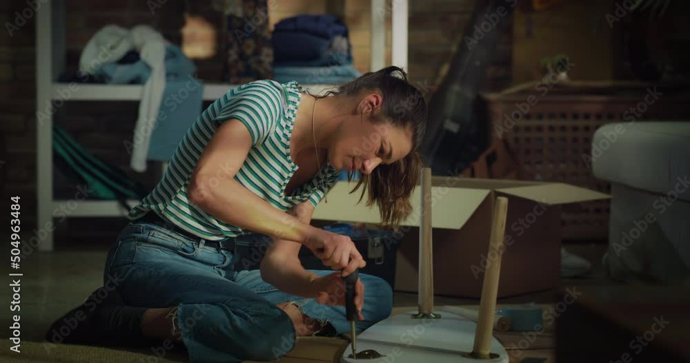 Cinematic shot of young creative woman is assembling wooden table to remodeling and renovation house by herself with diy techniques at home. Cinematic shot of young creative woman is assembling wooden table to remodeling and renovation house by herself with diy techniques at home.