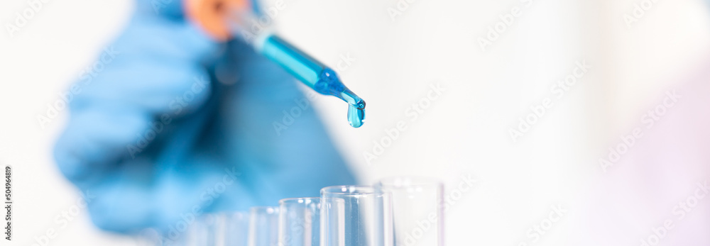 Scientists are carrying blue chemical test tubes to prepare for the determination of chemical composition and biological mass in a scientific laboratory, Scientists and research in the lab Concept. Scientists are carrying blue chemical test tubes to prepare for the determination of chemical composition and biological mass in a scientific laboratory, Scientists and research in the lab Concept.