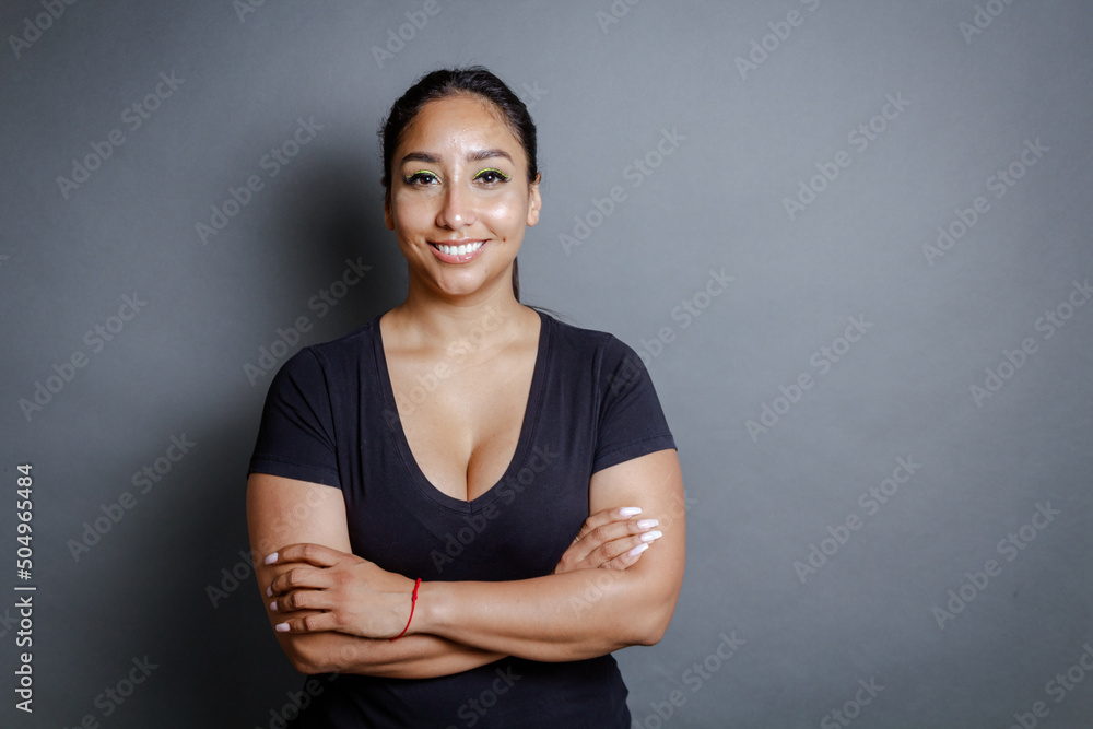 Obraz premium portrait of confident brunette hispanic young woman looking at camera smiling.