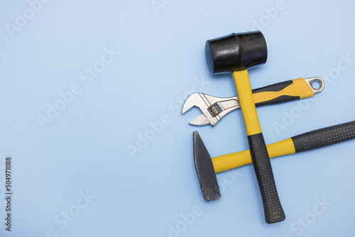 Fotografie hammer, mallet, sanitary key on a light blue background with copy space