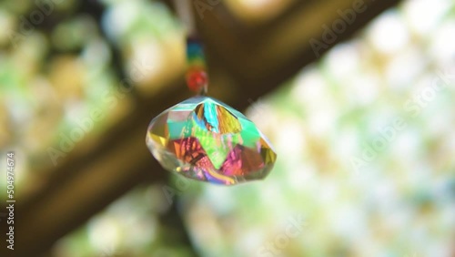 magial multicolored crystal reflecting chakra colors hanging from the ceiling unique spiritual shot slow motion relaxation photo