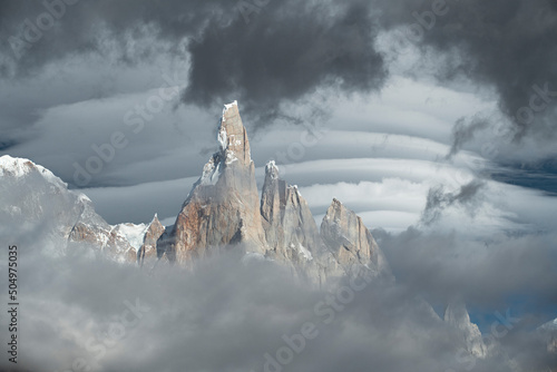 Lenticular clouds forming behind the misty peaks of Cerro Torre. photo