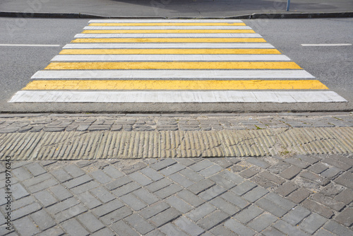 yellow and white pedestrian crossing, close-up