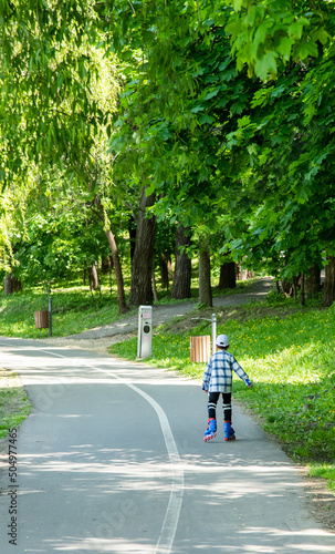 Child rollerblading in the city park © Miroslav Rotari