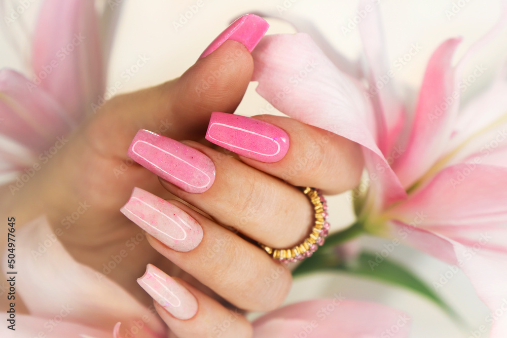 Pink elongated nail extension with fine glitter. - obrazy, fototapety, plakaty 
