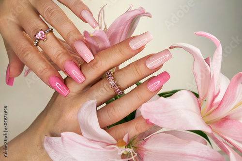 Pink elongated nail extension with fine glitter. photo