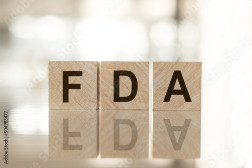 FDA. Text on wood cubes on mirror surface photo