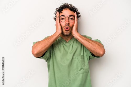 Young caucasian man isolated on white background being shocked, she has remembered important meeting. © Asier