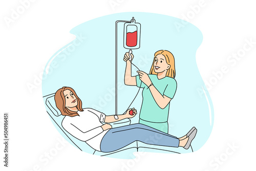 Female donor donate blood in clinic