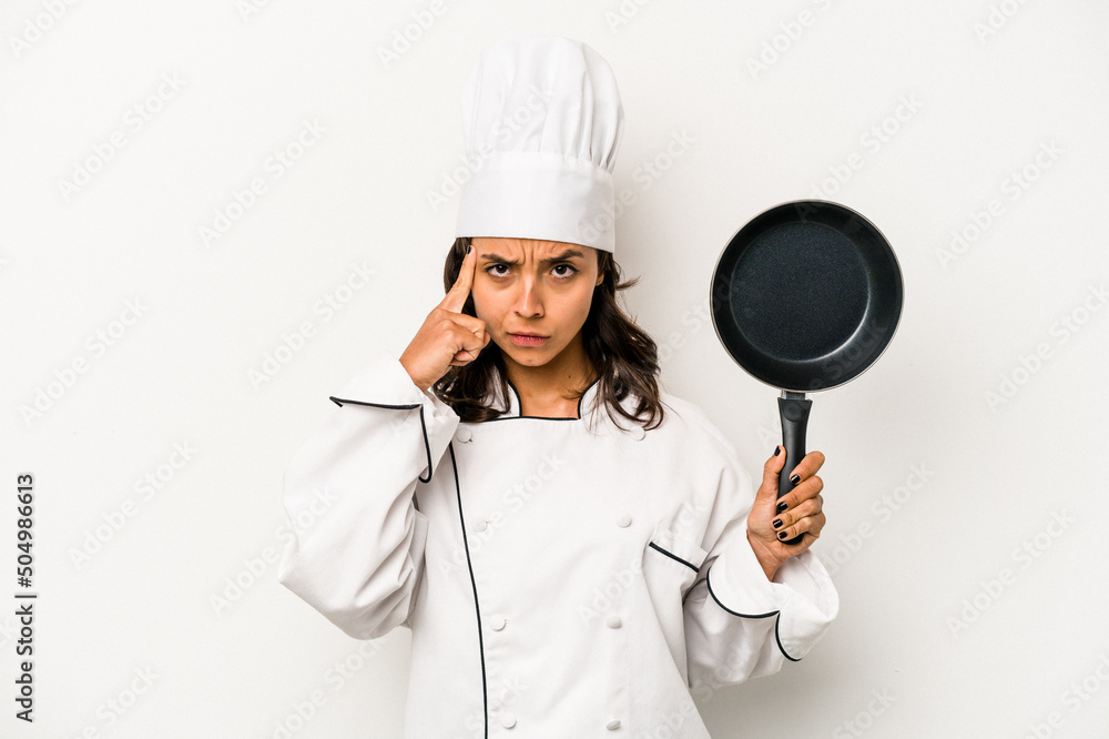 Young hispanic chef woman isolated on white background pointing temple with finger, thinking, focused on a task. Young hispanic chef woman isolated on white background pointing temple with finger, thinking, focused on a task.