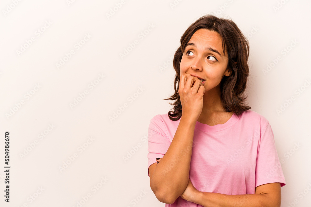 Fototapeta premium Young hispanic woman isolated on white background relaxed thinking about something looking at a copy space.