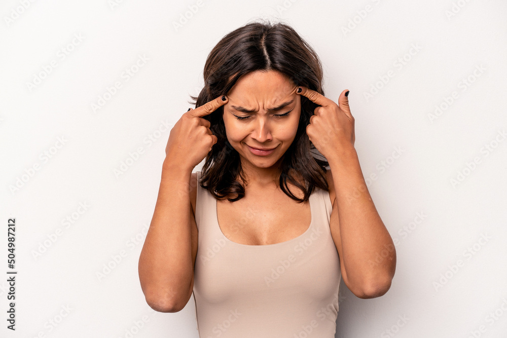 Young hispanic woman isolated on white background focused on a task, keeping forefingers pointing head. Young hispanic woman isolated on white background focused on a task, keeping forefingers pointing head.