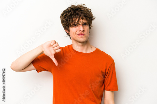 Young caucasian man isolated on white background showing thumb down, disappointment concept.