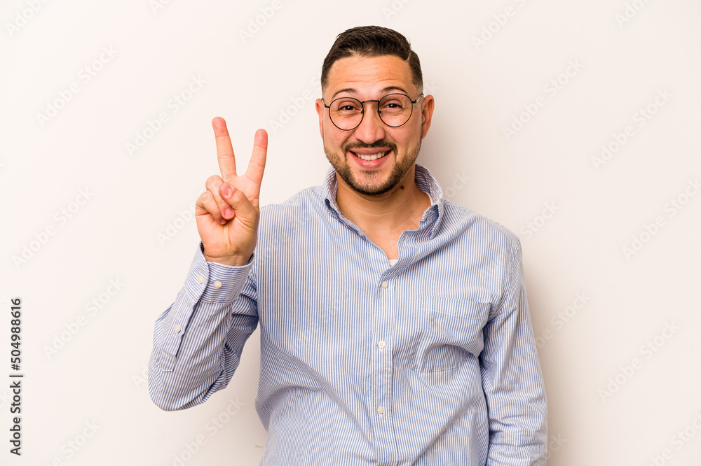 Young hispanic man isolated on white background showing number two with fingers. Young hispanic man isolated on white background showing number two with fingers.