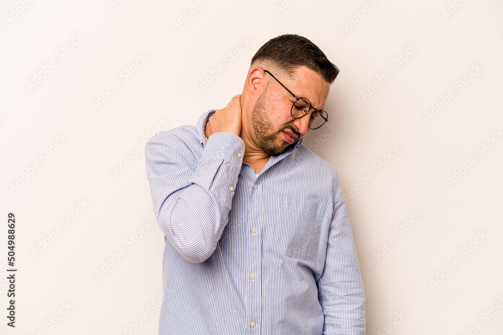 Young hispanic man isolated on white background having a neck pain due to stress, massaging and touching it with hand. Young hispanic man isolated on white background having a neck pain due to stress, massaging and touching it with hand.
