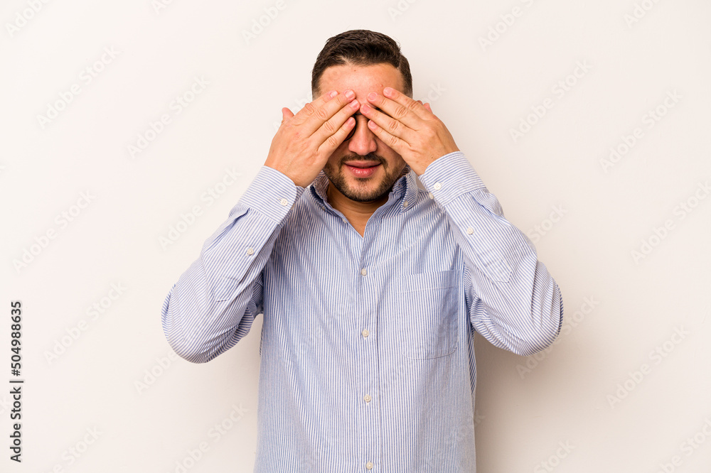 Young hispanic man isolated on white background afraid covering eyes with hands. Young hispanic man isolated on white background afraid covering eyes with hands.