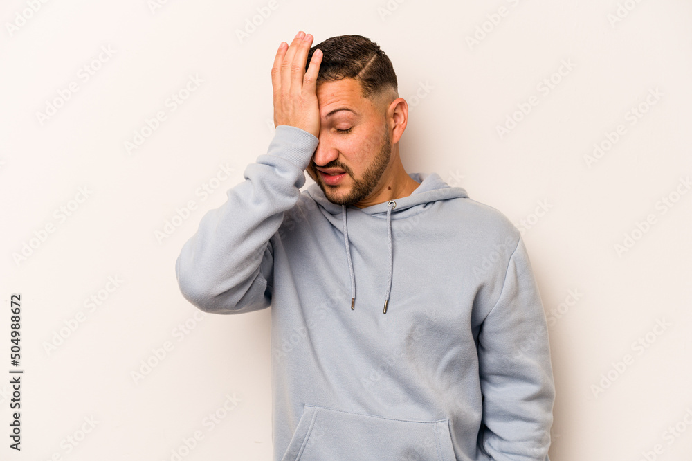 Young hispanic man isolated on white background forgetting something, slapping forehead with palm and closing eyes. Young hispanic man isolated on white background forgetting something, slapping forehead with palm and closing eyes.