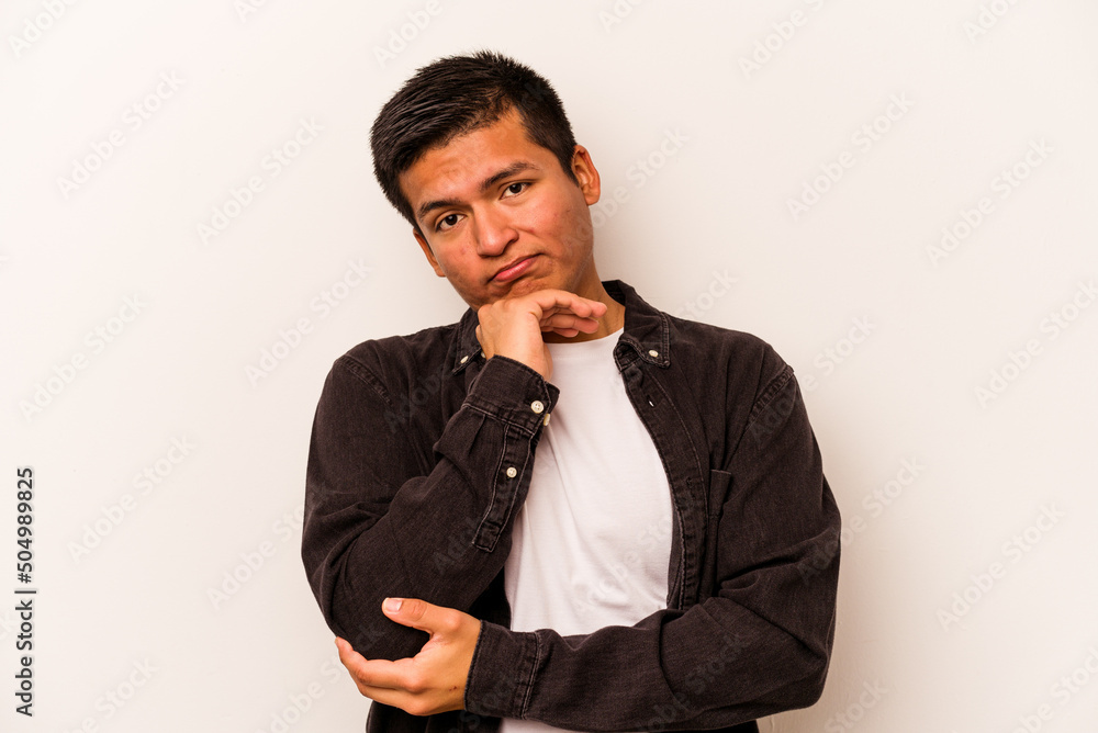 Young hispanic man isolated on white background tired of a repetitive task. Young hispanic man isolated on white background tired of a repetitive task.