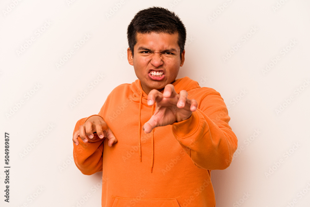 Young hispanic man isolated on white background showing claws imitating a cat, aggressive gesture. Young hispanic man isolated on white background showing claws imitating a cat, aggressive gesture.