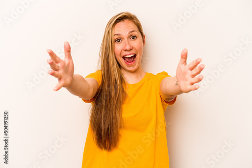 Young caucasian woman isolated on white background celebrating a victory or success, he is surprised and shocked.