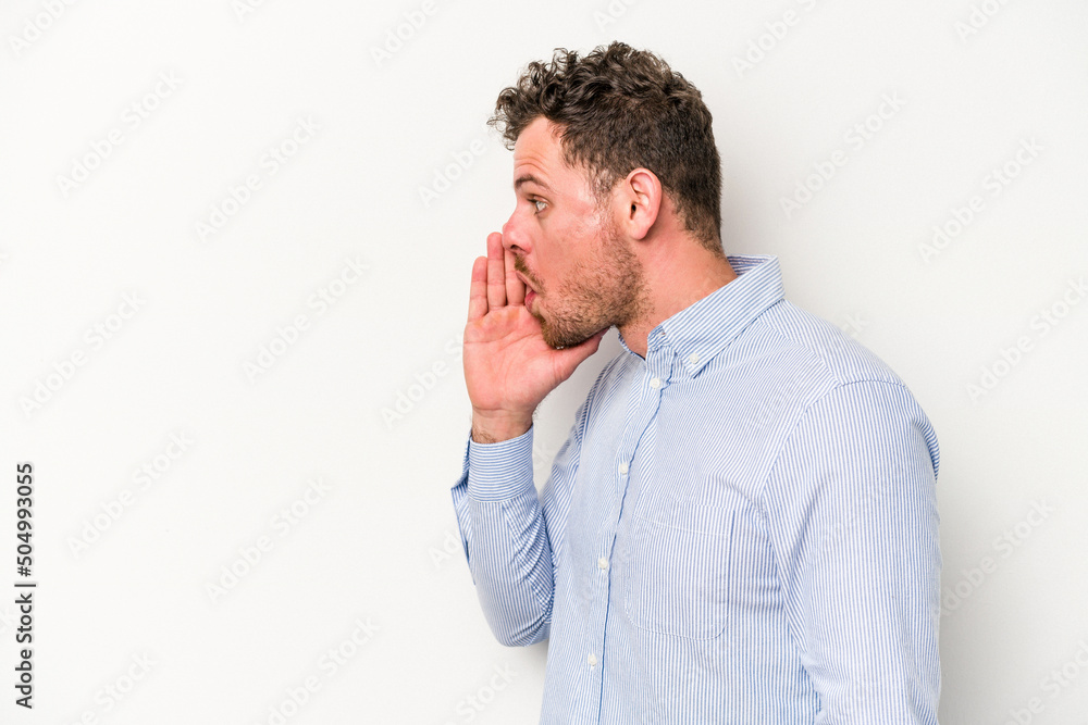 Young caucasian man isolated on white background is saying a secret hot braking news and looking aside Young caucasian man isolated on white background is saying a secret hot braking news and looking aside