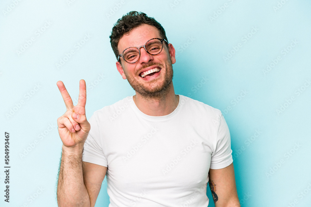 © Asier - Young caucasian man isolated on blue background showing number two with fingers.