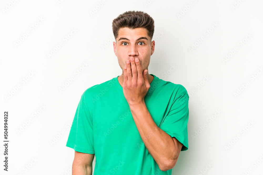 Young caucasian man isolated on white background shocked, covering mouth with hands, anxious to discover something new. Young caucasian man isolated on white background shocked, covering mouth with hands, anxious to discover something new.