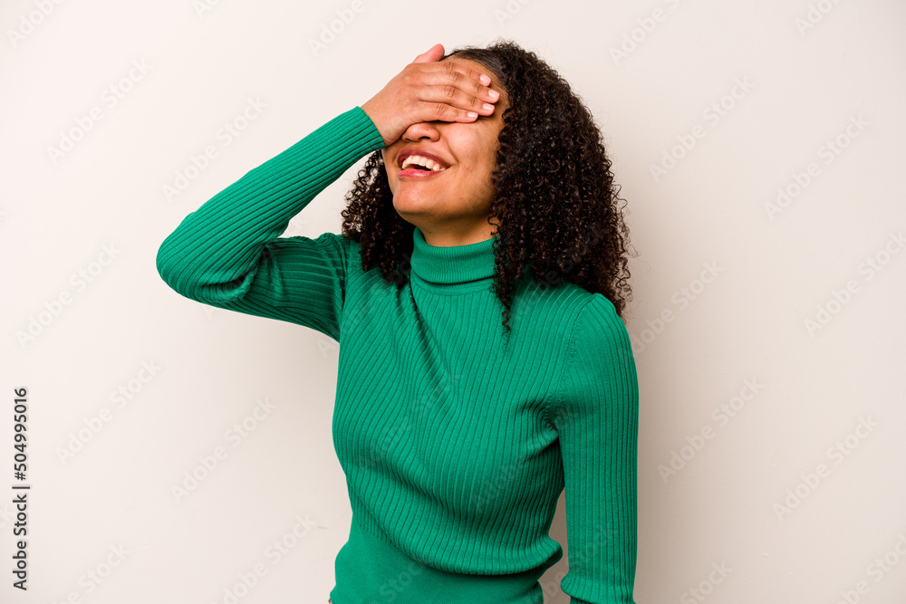Young African American woman isolated on white background laughs joyfully keeping hands on head. Happiness concept. Young African American woman isolated on white background laughs joyfully keeping hands on head. Happiness concept.