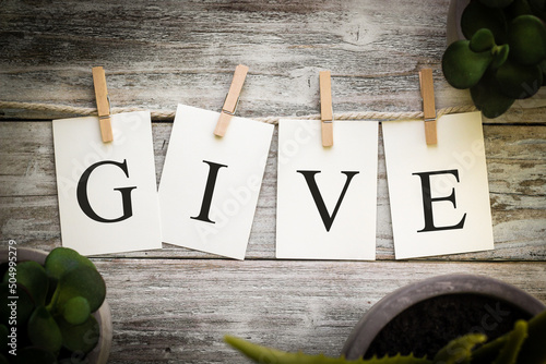 Φωτογραφία The Word GIVE Concept Printed on Cards