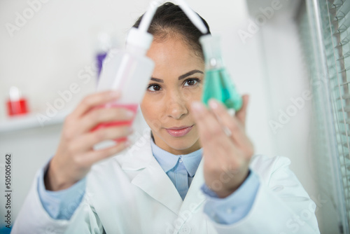 woman in white uniform in laboratory work on analize photo