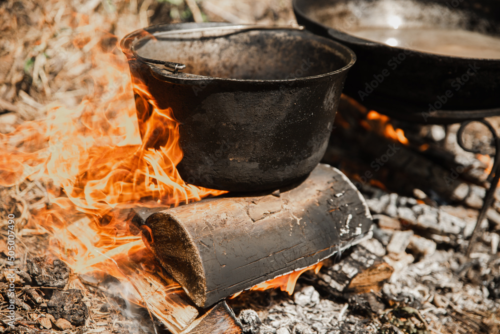 Ukrainian national dish - borscht. Outdoor cooking on wood fire Ukrainian national dish - borscht. Outdoor cooking on wood fire