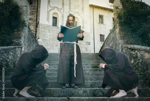 Templar monk reads the sacred scriptures to his monk brothers. photo