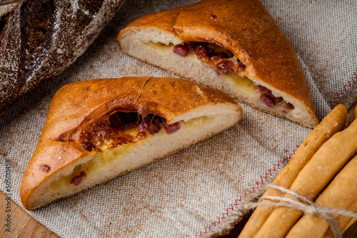 Fresh bun, sliced bun. Bread on a brown background. Rural food. Homemade pastries
