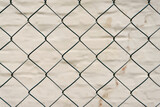metal mesh and a brick wall behind it